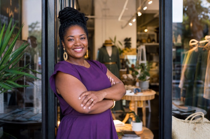 Small business owner in her boutique doorway